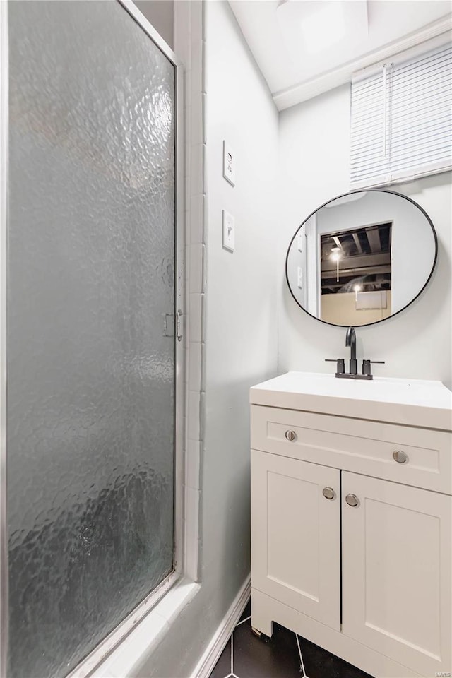 bathroom featuring tile patterned floors, vanity, and walk in shower