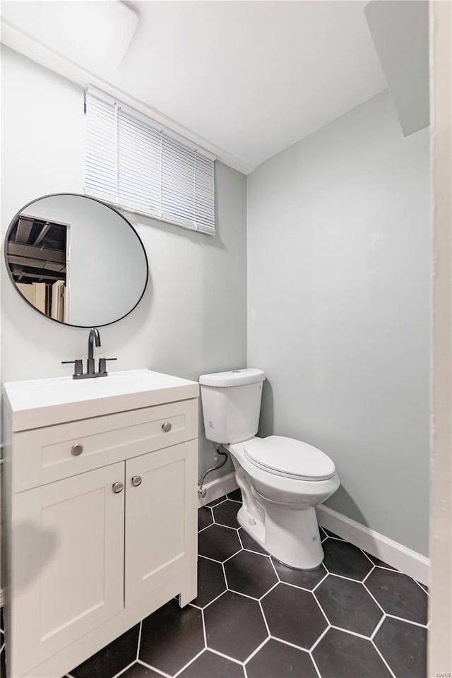 bathroom featuring tile patterned floors, vanity, and toilet