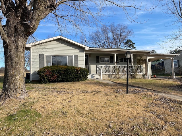 view of front of house featuring a carport, a porch, and a front lawn