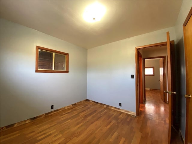 empty room with dark wood-type flooring