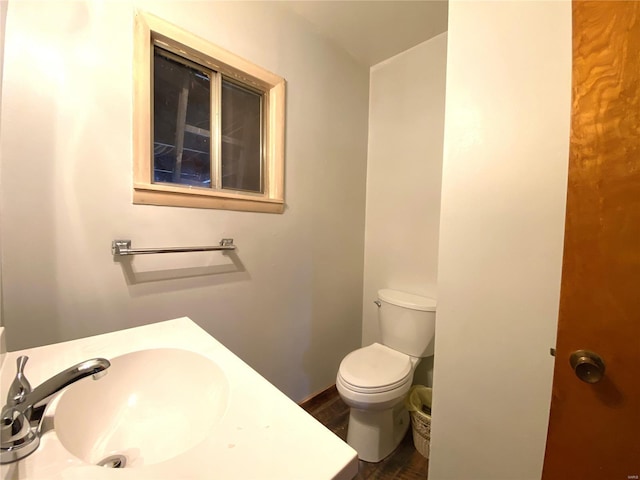 bathroom featuring hardwood / wood-style flooring, vanity, and toilet