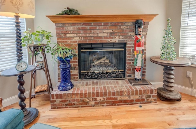 interior details with hardwood / wood-style flooring and a brick fireplace