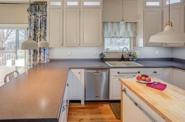 kitchen with dishwasher, white cabinetry, plenty of natural light, and sink