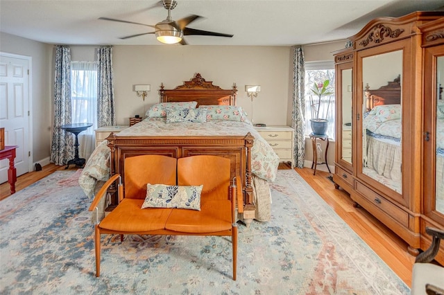 bedroom with ceiling fan and light wood-type flooring