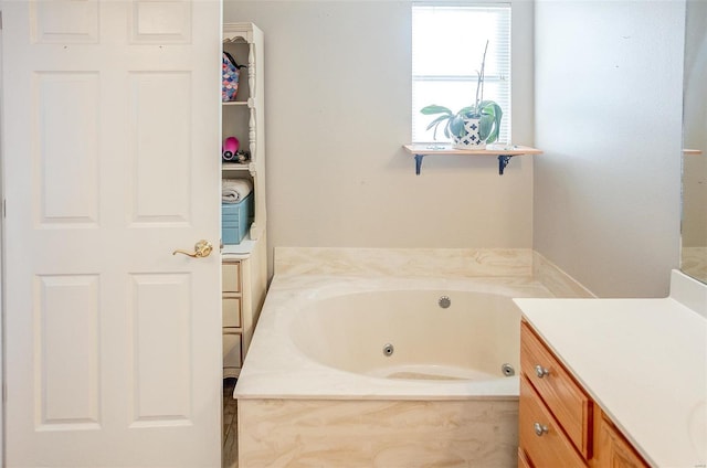 bathroom with vanity and a relaxing tiled tub