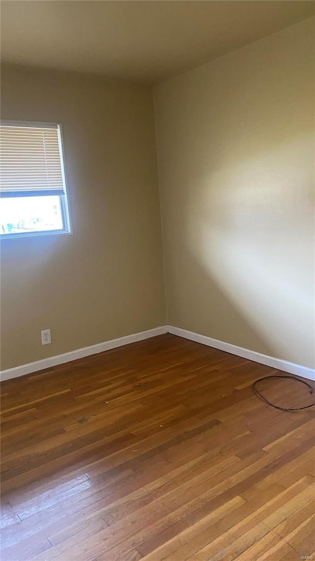 unfurnished room with wood-type flooring