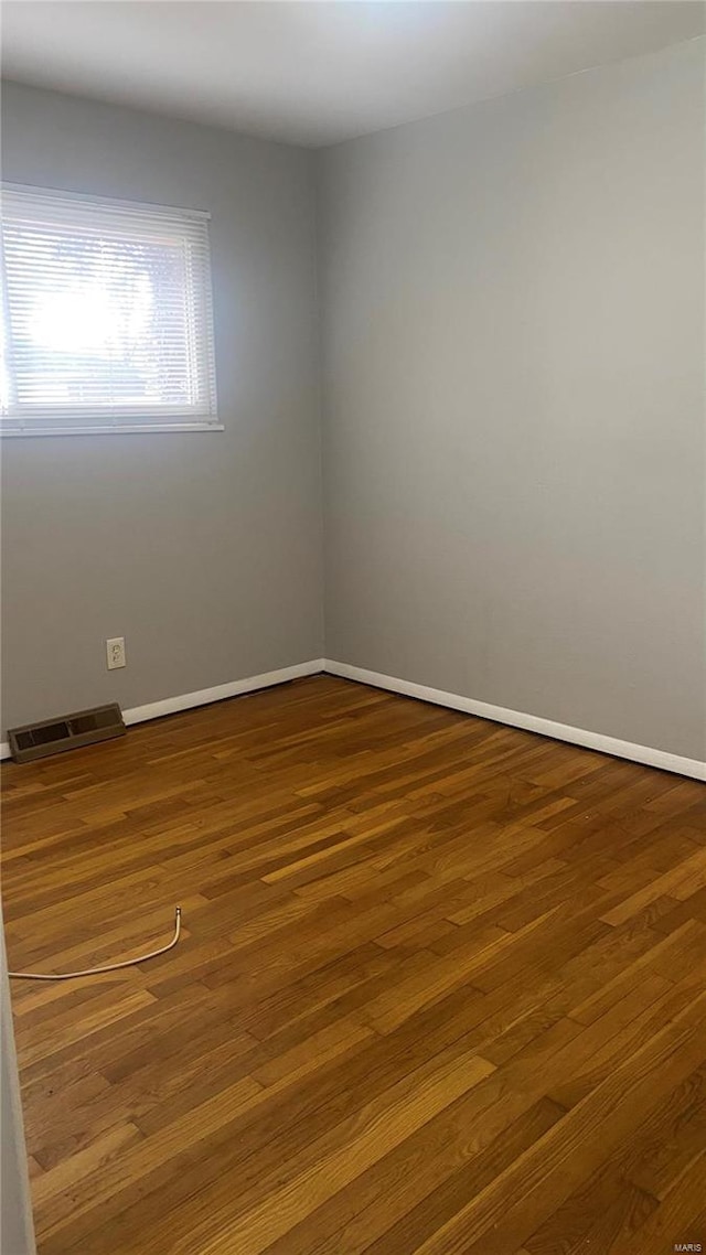 spare room with hardwood / wood-style flooring