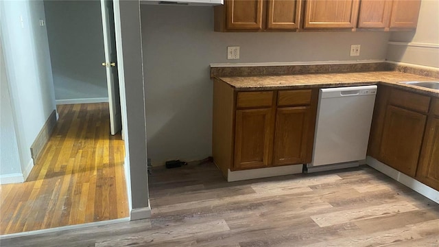 kitchen featuring white dishwasher and light wood-type flooring