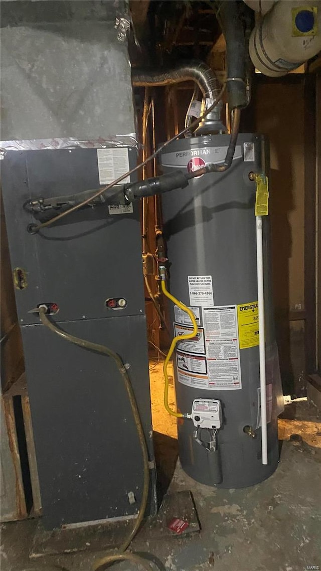 utility room featuring heating unit and gas water heater