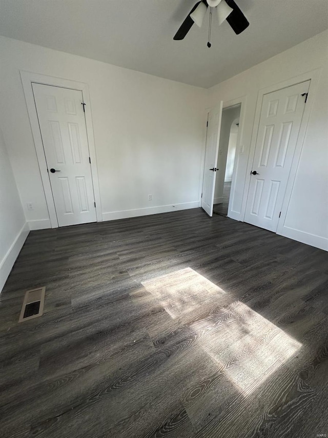 unfurnished room featuring ceiling fan and dark hardwood / wood-style floors