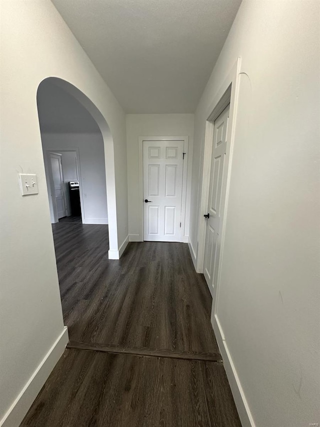 corridor with dark hardwood / wood-style floors