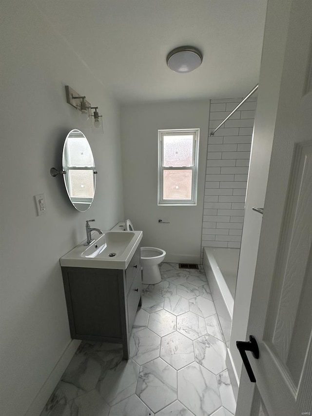 bathroom with vanity, toilet, and a tile shower