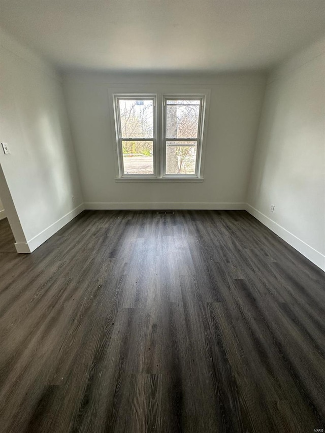 unfurnished room featuring dark hardwood / wood-style flooring