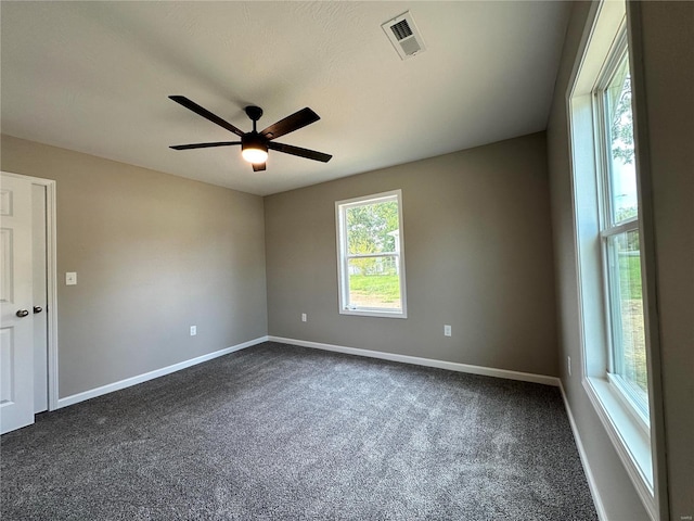 carpeted spare room featuring ceiling fan