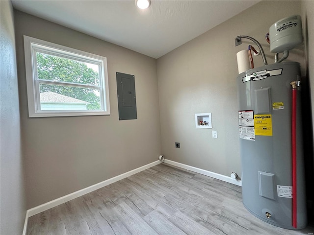 washroom with electric panel, light hardwood / wood-style flooring, washer hookup, water heater, and hookup for an electric dryer