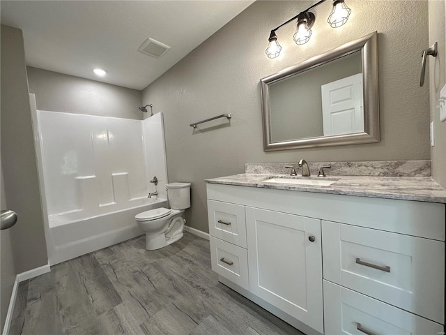 full bathroom featuring hardwood / wood-style floors, vanity, shower / bathtub combination, and toilet