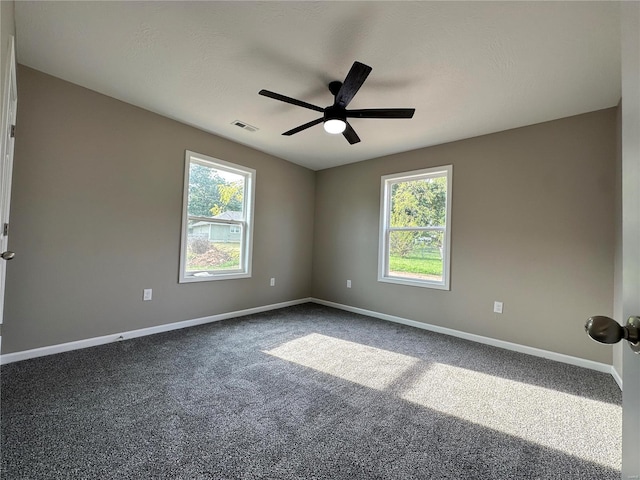 unfurnished room featuring ceiling fan, carpet floors, and a healthy amount of sunlight