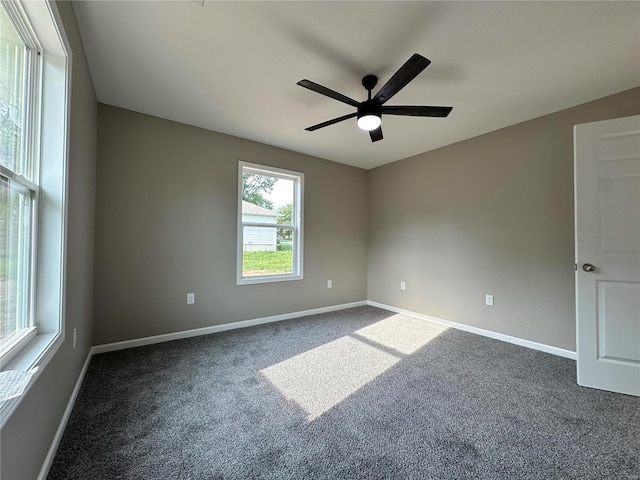 carpeted empty room featuring ceiling fan