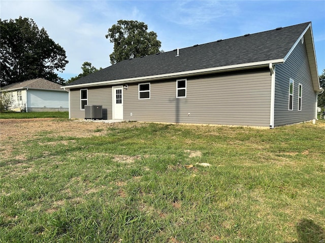 rear view of house featuring a yard and cooling unit