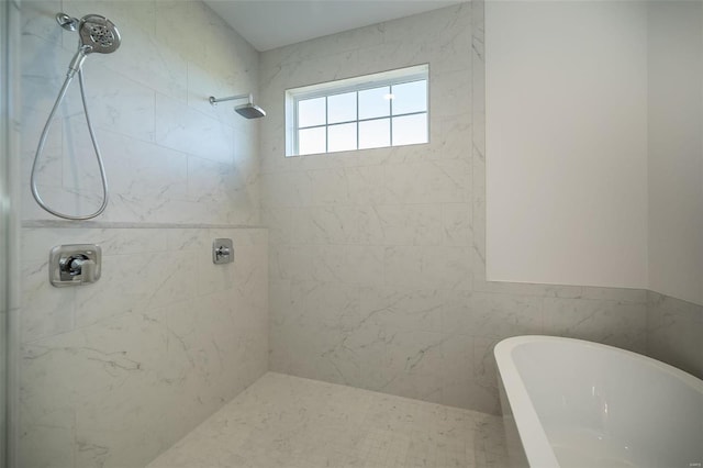 bathroom featuring separate shower and tub and tile walls