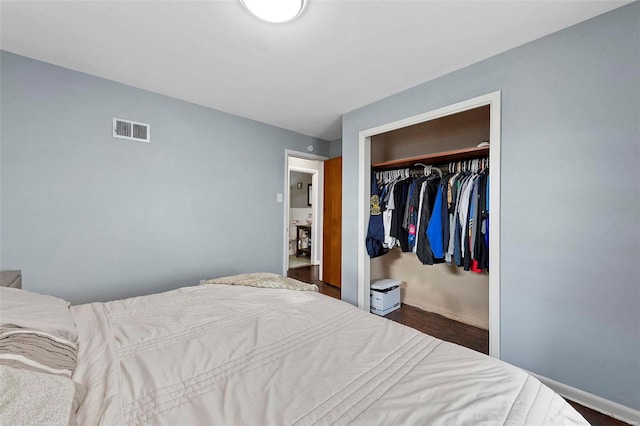 bedroom with a closet and dark wood-type flooring