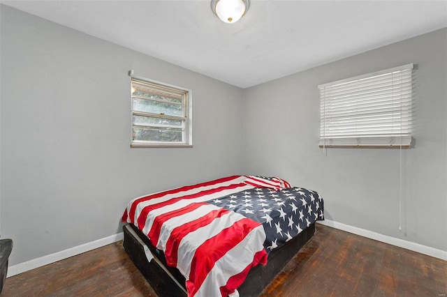 bedroom with dark wood-type flooring