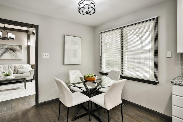 dining area featuring dark hardwood / wood-style flooring and a notable chandelier