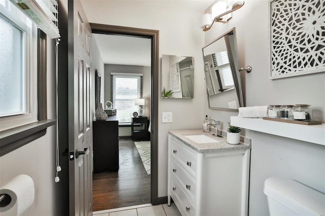 bathroom featuring tile patterned flooring, vanity, and toilet