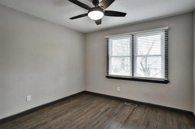 unfurnished room featuring ceiling fan and dark wood-type flooring