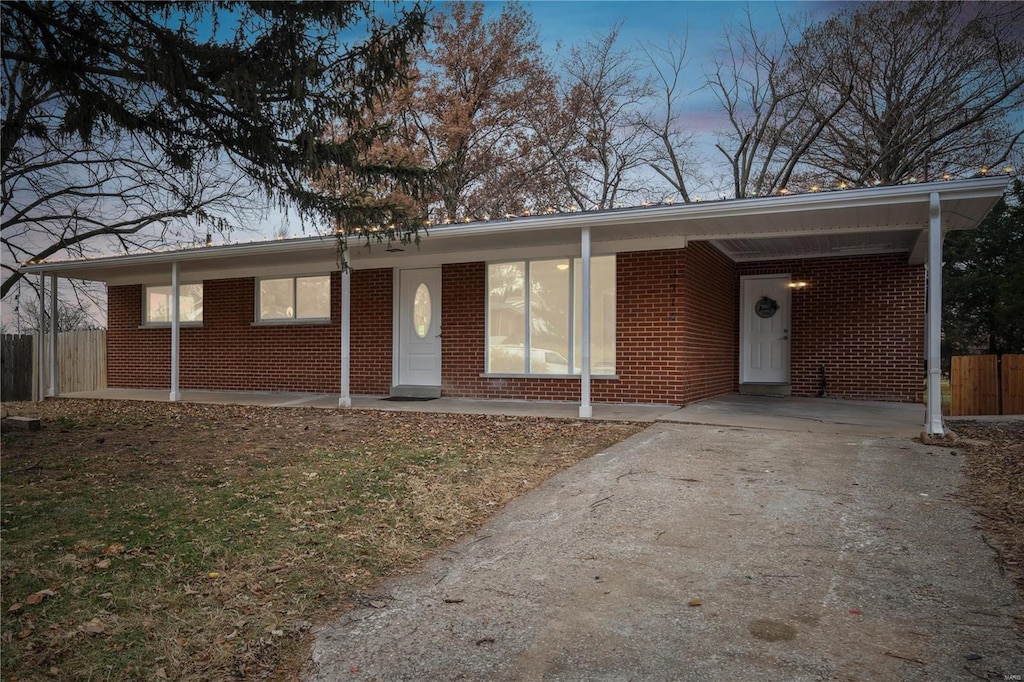 ranch-style house featuring a carport