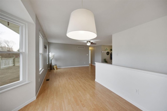 unfurnished room featuring light hardwood / wood-style floors and ceiling fan