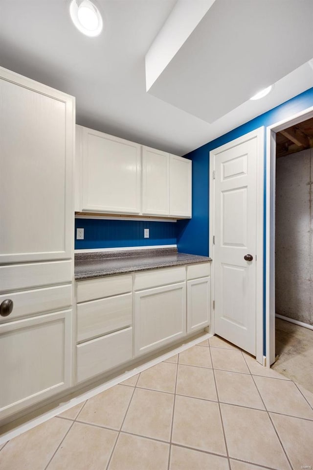 kitchen with white cabinets and light tile patterned floors