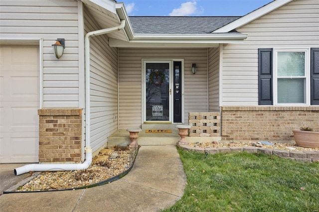 view of exterior entry with a garage