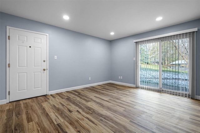 spare room with wood-type flooring