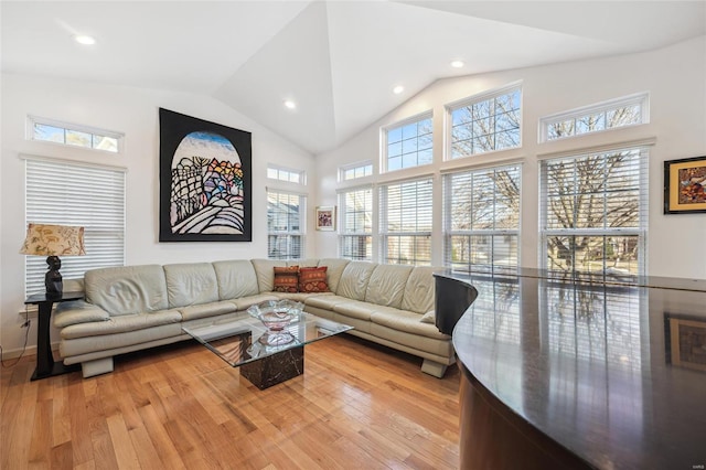 living room featuring light hardwood / wood-style flooring and high vaulted ceiling