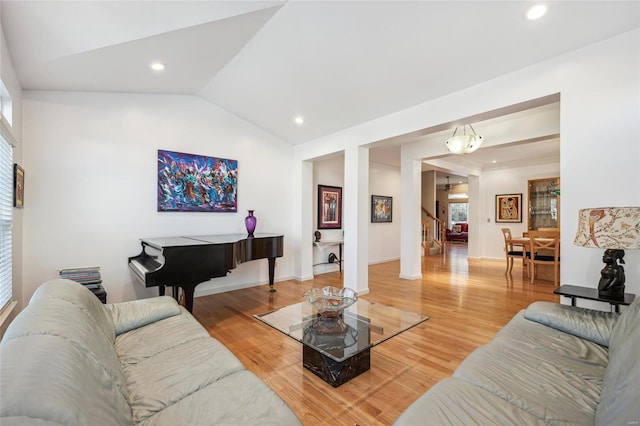 living room featuring vaulted ceiling and hardwood / wood-style floors