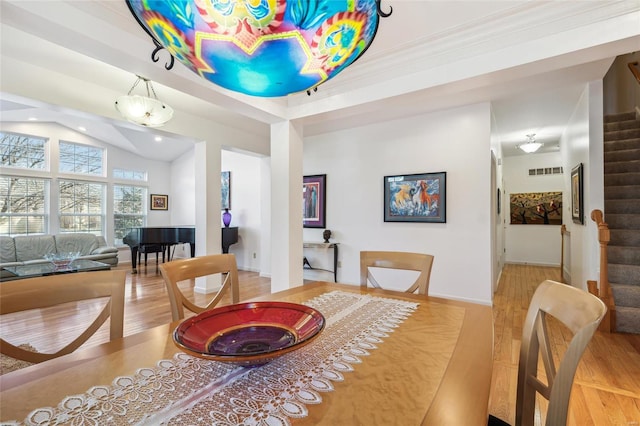 dining area with crown molding and light hardwood / wood-style floors