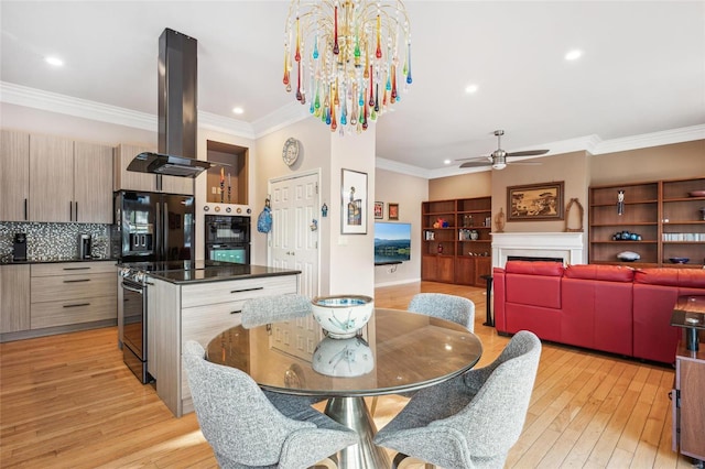 dining room featuring ceiling fan with notable chandelier, ornamental molding, and light wood-type flooring