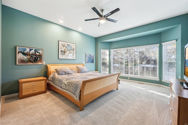 bedroom with light carpet and ceiling fan