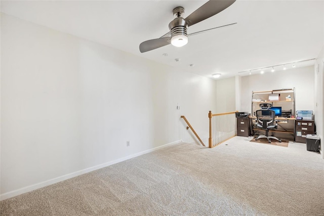 carpeted home office featuring track lighting and ceiling fan