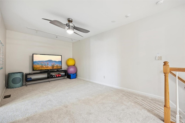 interior space featuring carpet flooring, track lighting, and ceiling fan