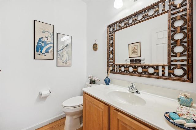 bathroom with vanity, hardwood / wood-style flooring, and toilet