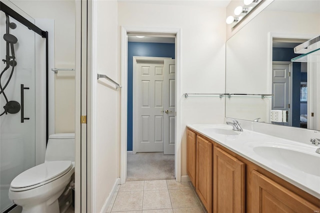 bathroom featuring tile patterned flooring, vanity, and toilet