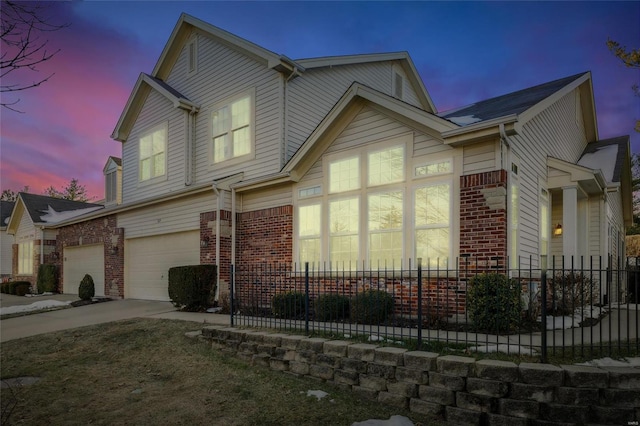 property exterior at dusk featuring a garage