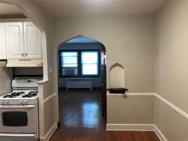 kitchen with white cabinets, radiator heating unit, dark hardwood / wood-style flooring, and gas range gas stove