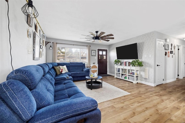 living room featuring hardwood / wood-style floors and ceiling fan