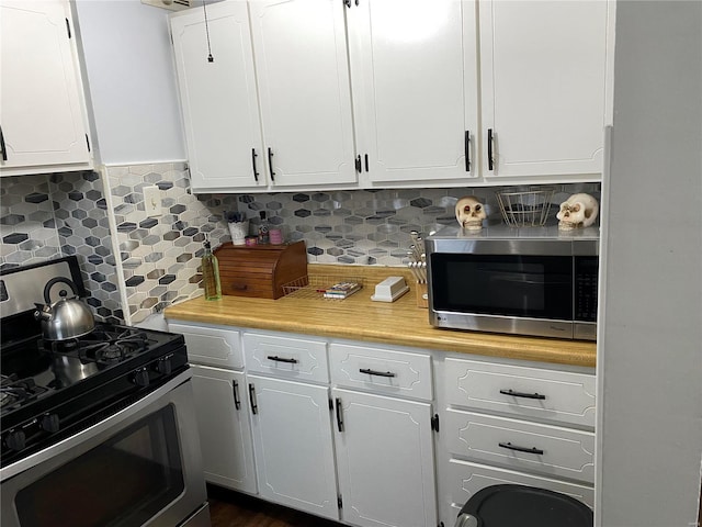 kitchen featuring white cabinets, decorative backsplash, and stainless steel appliances