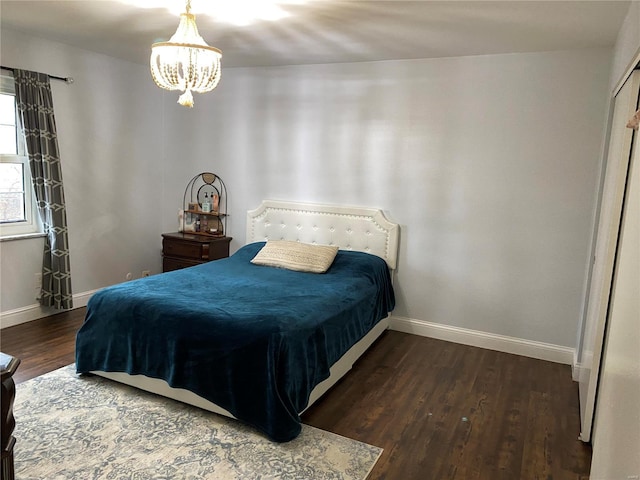 bedroom featuring a chandelier and dark hardwood / wood-style floors