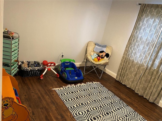 game room with dark hardwood / wood-style flooring