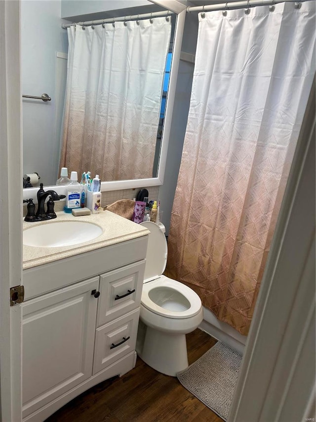 bathroom featuring hardwood / wood-style floors, vanity, and toilet